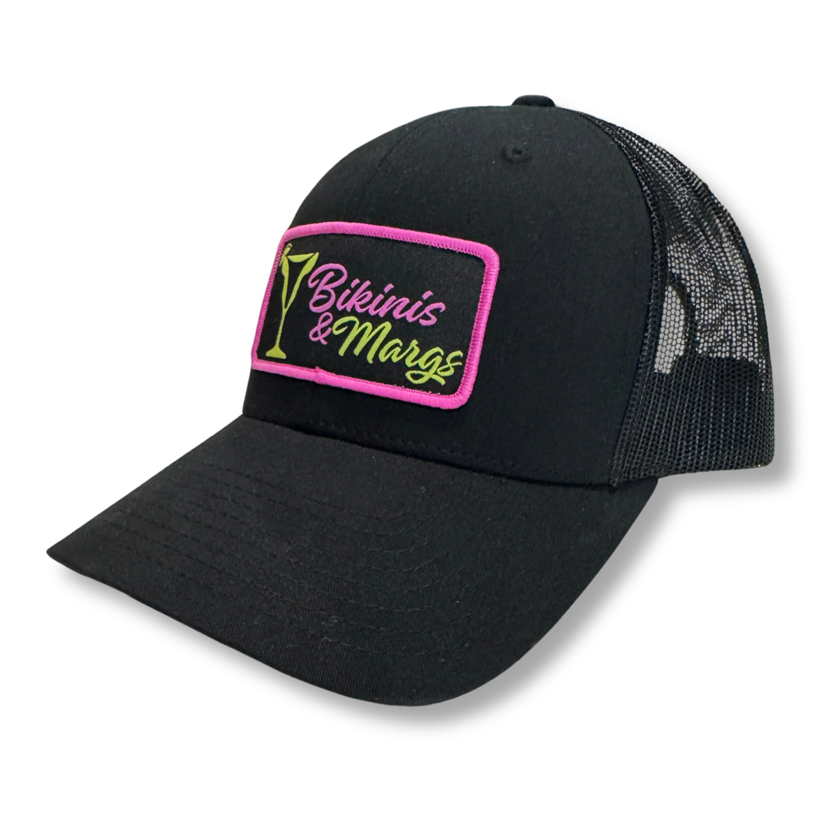 A black trucker-style cap with a curved brim, black mesh back, and a rectangular embroidered patch on the front reading 'Bikinis & Margs' in neon pink and green.
