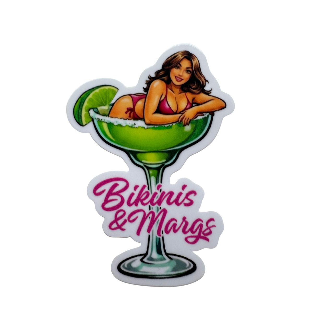 A die-cut sticker featuring a cartoon pin-up style woman reclining in a green margarita glass with a lime wedge, above the pink script text 'Bikinis & Margs', on a plain white background.