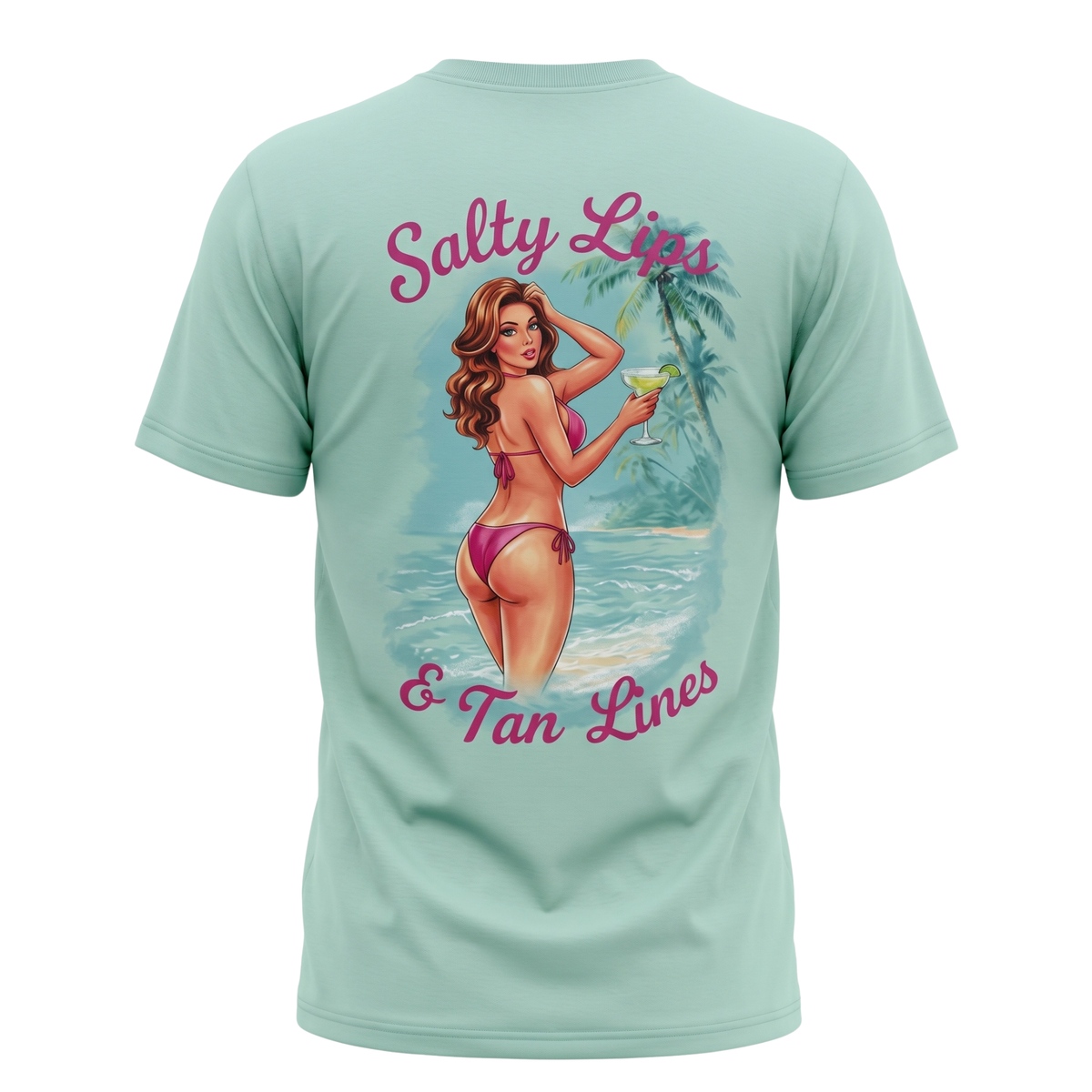A mint green short-sleeve t-shirt shown from the back, featuring a large graphic print of a retro pin-up woman in a pink bikini on a tropical beach with the text 'Salty Lips & Tan Lines' in pink script.